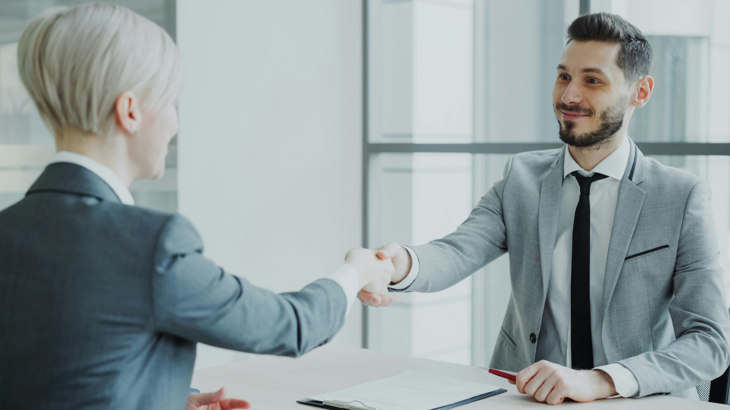 Two business professionals shaking hands after a successful meeting